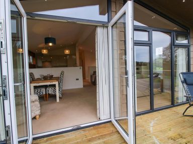 A dining area with a table and chairs at 5 Hillview Lodges in Cleobury Mortimer