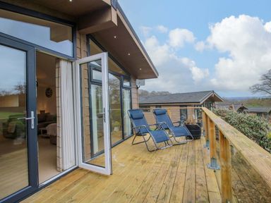 A deck with chairs and views at 5 Hillview Lodges in Cleobury Mortimer