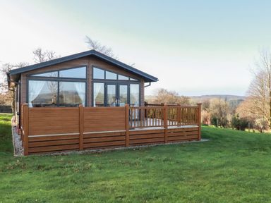 A wooden deck with a house at Moorland View in 