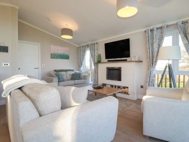 A living room with a sofa and television at Moorland View