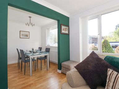 A dining room with a table and chairs at Wansfell View in Ambleside