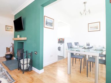 A dining room with a table and chairs at Wansfell View in Ambleside