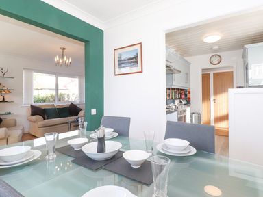 A dining room with a table set for a meal at Wansfell View in Ambleside