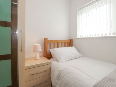 A bedroom with a single bed and a nightstand at Wansfell View in Ambleside