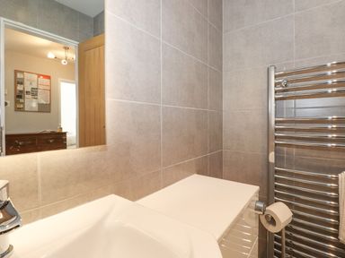 A bathroom with a sink and towel rack at Wansfell View in Ambleside