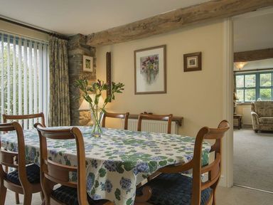 A dining room with a table and chairs at Pillars in Barnstaple