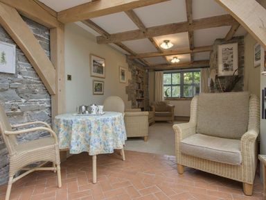 A living room with a table and chairs at Pillars in Barnstaple