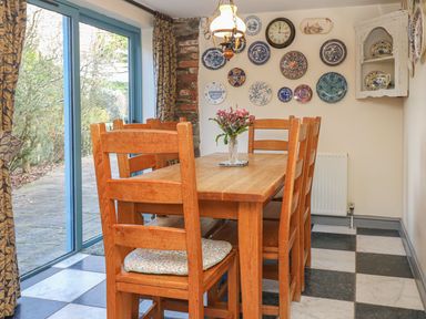 A dining room with a table and chairs at Pillars in Barnstaple