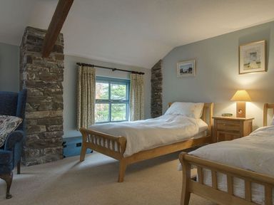A bedroom with two beds and a window at Pillars in Barnstaple