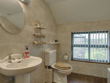 A bathroom with a sink and toilet at Pillars in Barnstaple