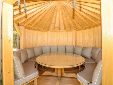 A seating area with cushions and a circular table at Pillars Barnstaple