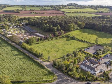 An aerial view of a landscape with buildings and fields at Cedar Lodge 3 Bedrooms with hot tub in Delamere