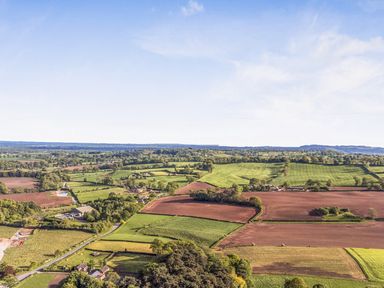 An aerial view of farmland and houses at Cedar Lodge 3 Bedrooms with hot tub in Delamere