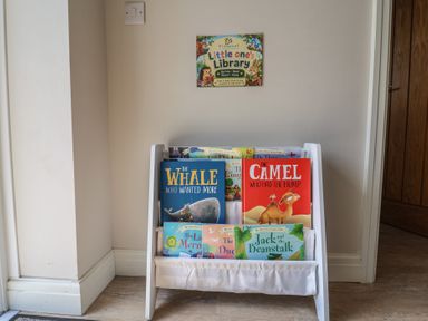 A book rack with children's books at Cedar Lodge 3 Bedrooms with hot tub, Delamere