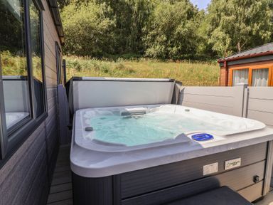 A hot tub in an outdoor area at Cedar Lodge 3 Bedrooms with hot tub Delamere