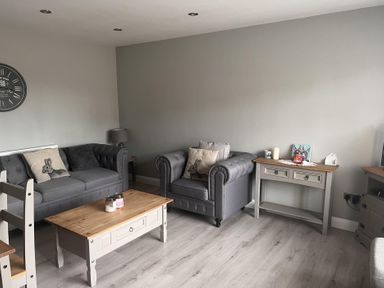 A living room with sofas and a coffee table at 43 Goose Green Road in King's Lynn