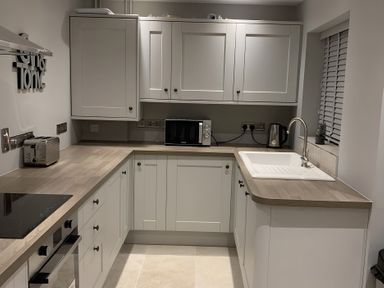 A kitchen with cabinets and appliances at 43 Goose Green Road in King's Lynn