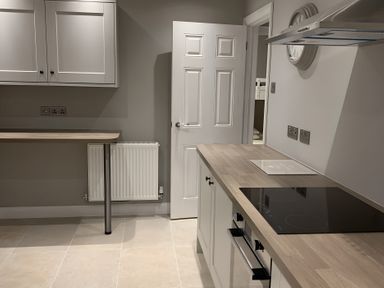 A kitchen with cabinets and a stove at 43 Goose Green Road in King's Lynn