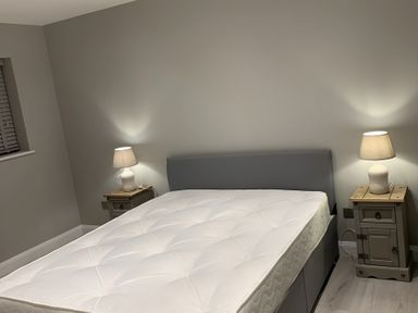 A bedroom with a bed and bedside tables at 43 Goose Green Road in King's Lynn