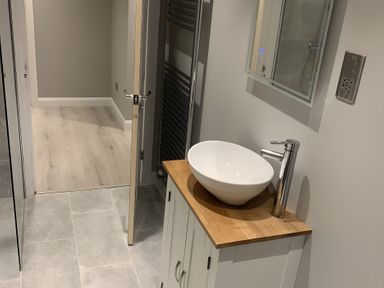 A bathroom with a sink on a wooden countertop at 43 Goose Green Road in King's Lynn