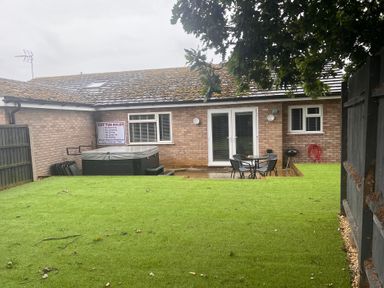 A garden with a hot tub and seating area at 43 Goose Green Road in King's Lynn