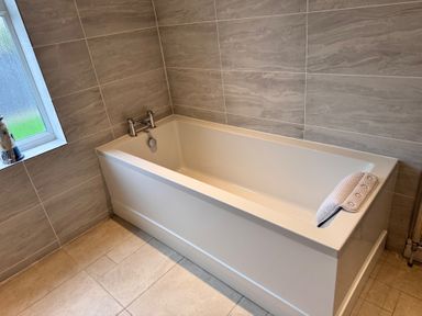 A bathroom with a bath tub and faucet at 15 Lamsey Lane King's Lynn