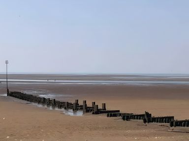 A beach with sea and groynes at 15 Lamsey Lane King's Lynn