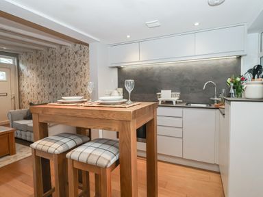 A kitchen with a table and chairs at No.4 Main Street in Hull