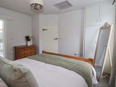 A bedroom with a bed and dresser at No.4 Main Street in Hull