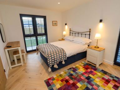 A bedroom with a bed and two lamps at 1 Dairy Fields Longframlington