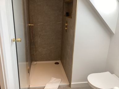 A bathroom with a shower and a toilet at The Barn in Longframlington