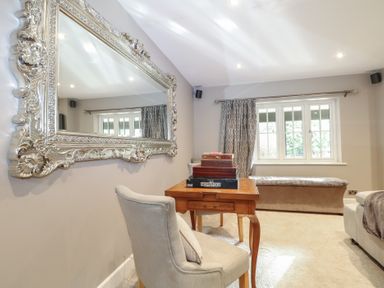 A study with a mirror, desk and window at Woodlands house Ringwood