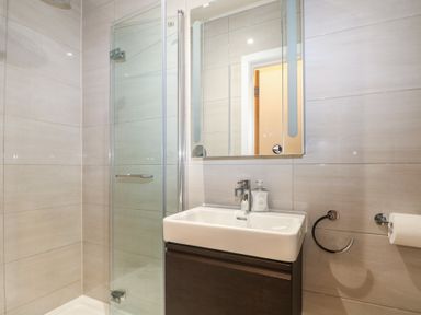 A bathroom with a shower and sink at Woodlands house in Ringwood