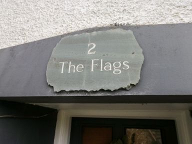 A sign reading 2 The Flags at the entrance of the property No.2 The Flags, Grange-over-Sands