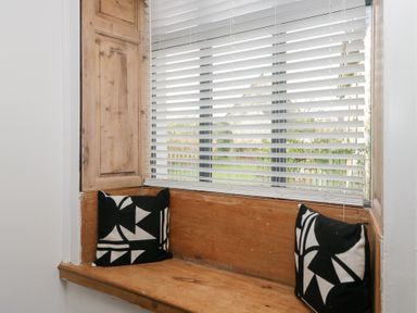 A nook with window, wooden seat and cushions at No.2 The Flags, Grange-over-Sands