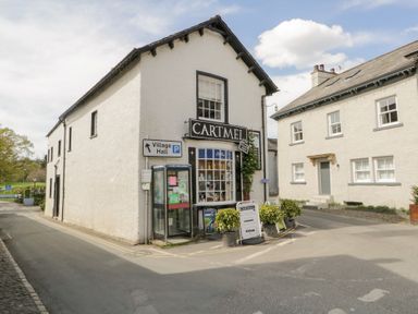 A building with shop signage on the corner at No.2 The Flags in Grange-over-Sands