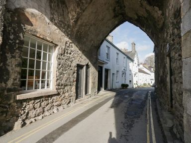 An archway with buildings and a road at No.2 The Flags, Grange-over-Sands