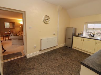 A kitchen with a fridge and sink at Easthwaite Cottage Holmrook near Easthwaite Farm
