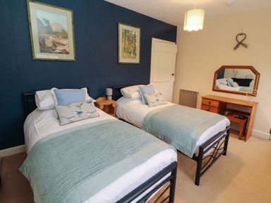 A bedroom with two single beds at Easthwaite Cottage Holmrook near Easthwaite Farm