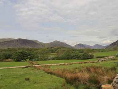 A landscape view of mountains and fields at Easthwaite Cottage in Nether Wasdale near Wastwater