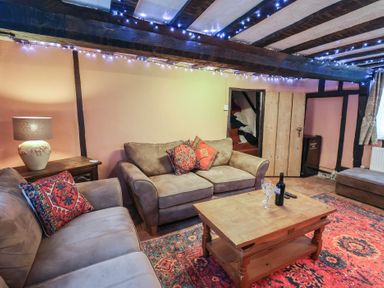 A living room with sofas and a coffee table at Driftway Cottage in Diss