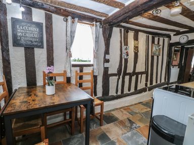 A kitchen with a wooden table and chairs at Driftway Stables Retreat, Diss