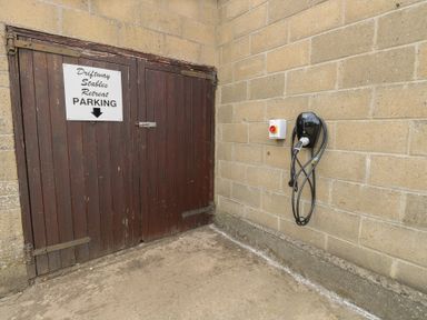 A parking sign and electric charging station at Driftway Stables Retreat in Diss