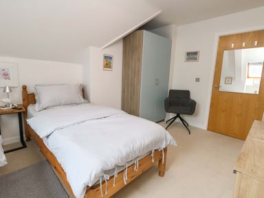 A bedroom with a bed and furniture at Flat 7 Weymouth