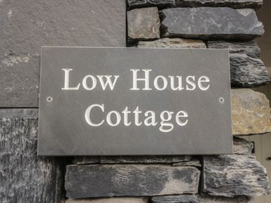 A nameplate on a stone wall at Low House Cottage in Ayside near Newby Bridge