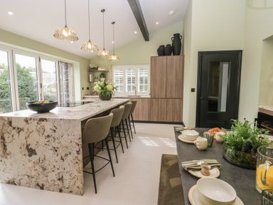 A kitchen with an island and bar stools at Low House Cottage Ayside near Newby Bridge