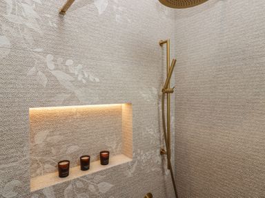 A shower area with candles in a niche at Low House Cottage Ayside near Newby Bridge