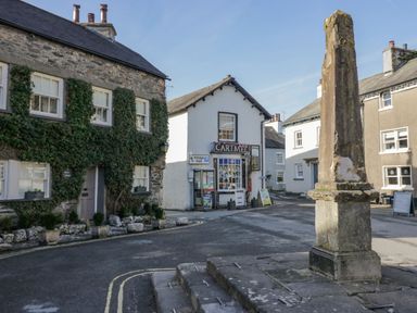 A street view with buildings and a sign at Low House Cottage Ayside near Newby Bridge