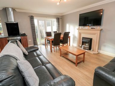 A living room with sofa and dining table at Megstone in Chathill