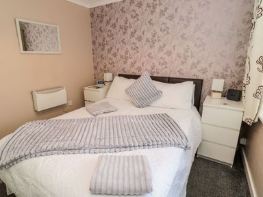 A bedroom with a bed and nightstand at Megstone in Chathill